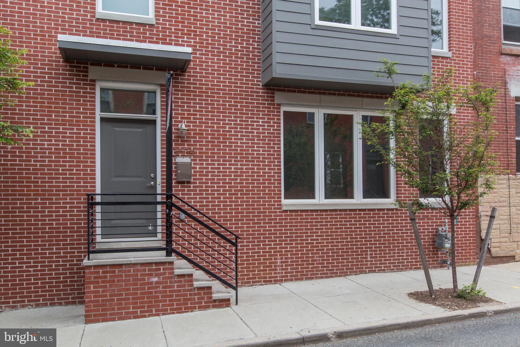 3039-41 Baltz Street Philadelphia, PA 19121 - Photo 35 of 35 a view of a brick house with a door and wooden floor