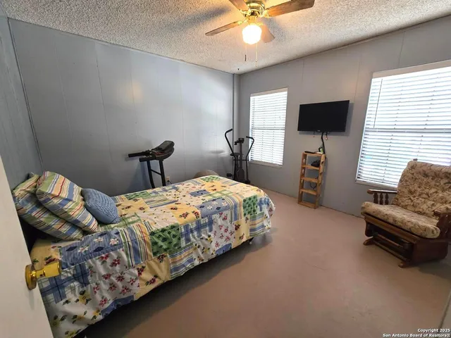 a bedroom with bed and window