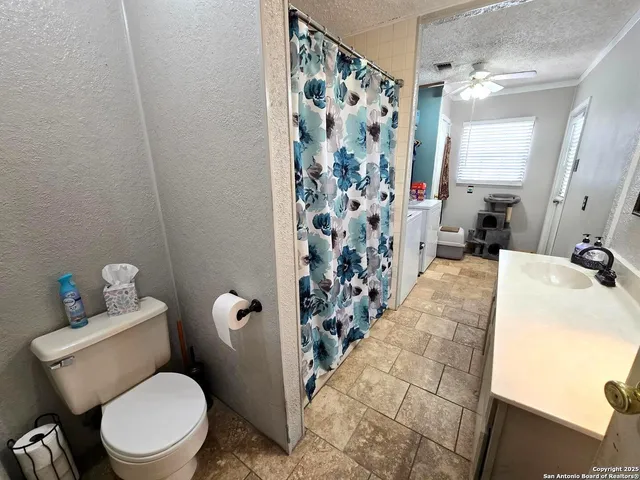 a white toilet sitting next to a bathroom sink