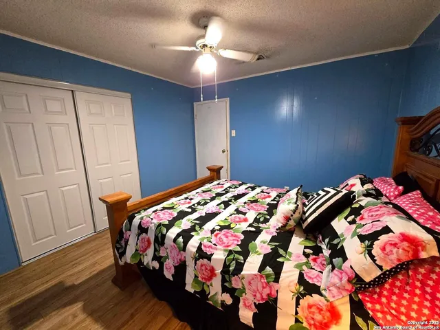 a bedroom with a bed and wooden floor