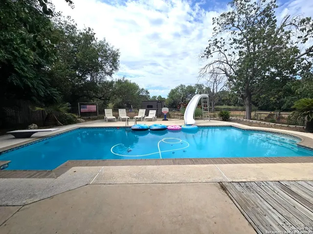 a view of a swimming pool with a patio