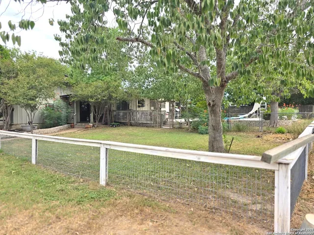 a view of a house with a backyard