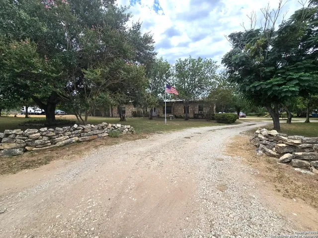 a backyard of a house with trees and houses