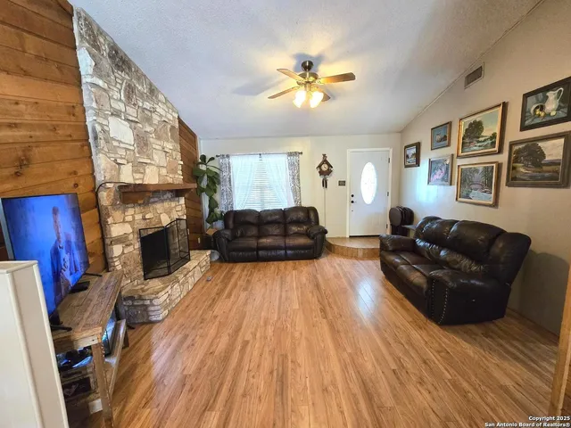 a living room with furniture and a fireplace