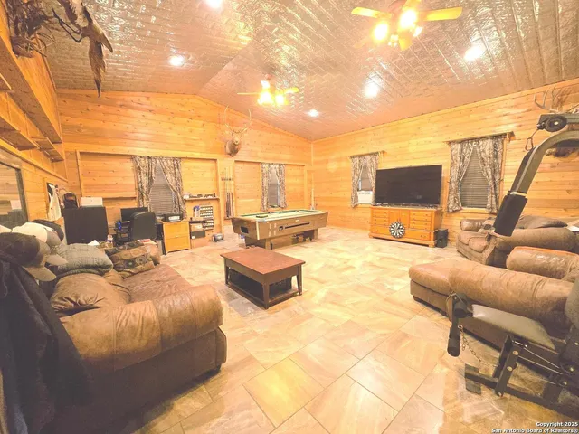 a outdoor living space with furniture and a flat screen tv