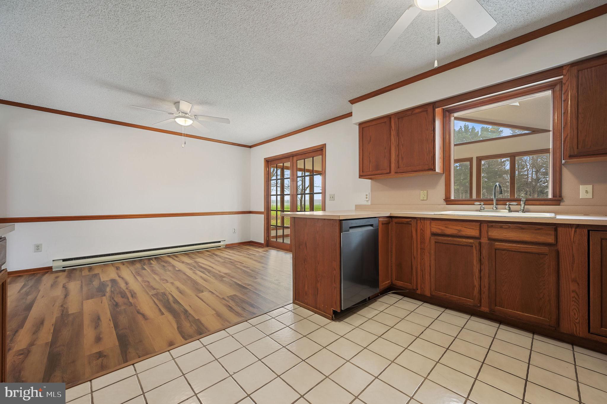 311 Sophers Row Magnolia, DE 19962 - Photo 13 of 40 a kitchen with stainless steel appliances granite countertop a refrigerator sink and cabinets