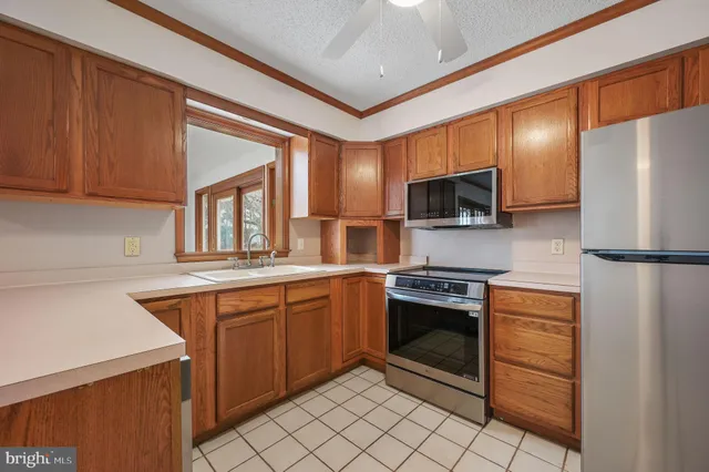 a kitchen with stainless steel appliances granite countertop a refrigerator and a sink