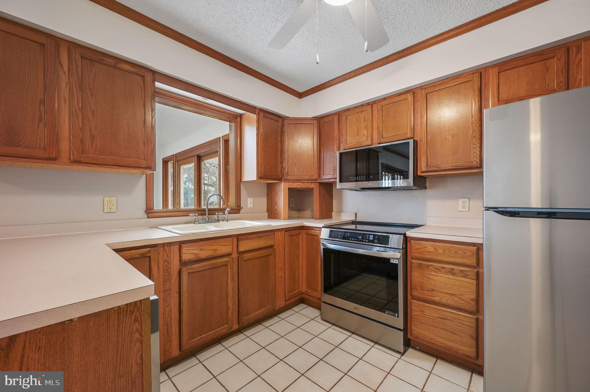 311 Sophers Row Magnolia, DE 19962 - Photo 14 of 40 a kitchen with stainless steel appliances granite countertop a refrigerator and a sink