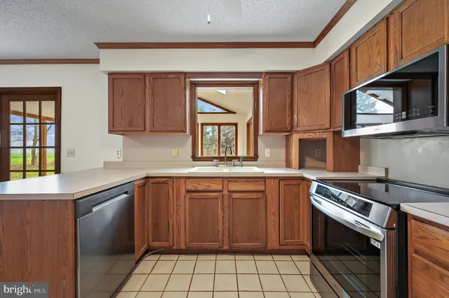 a kitchen with a sink stove and microwave