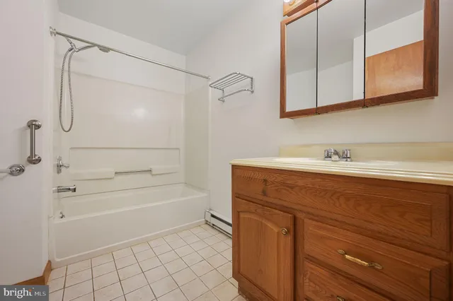 a bathroom with a shower and a sink