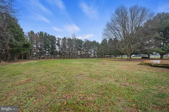 a view of outdoor space with deck and yard