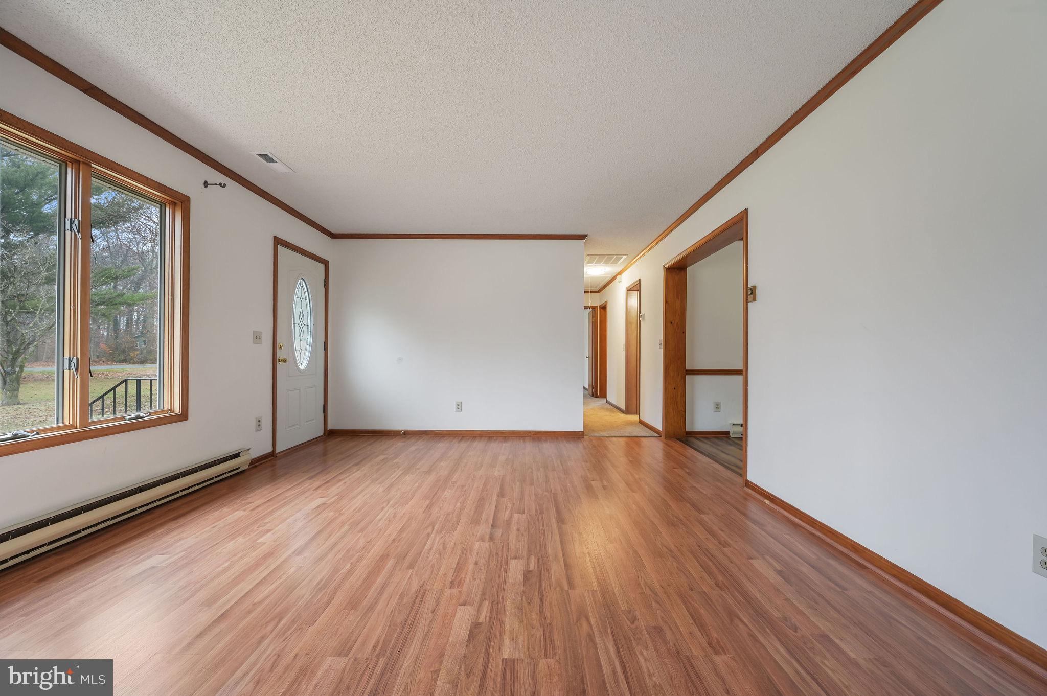 311 Sophers Row Magnolia, DE 19962 - Photo 7 of 40 a view of an empty room with wooden floor and a window
