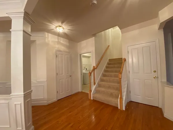a view of an entryway with wooden floor