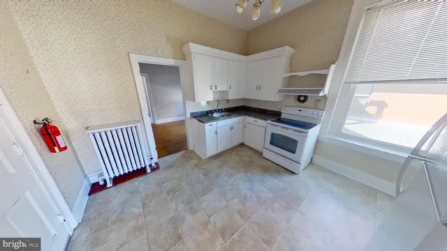 a kitchen with a refrigerator and a sink