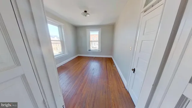 a view of a room with wooden floor and window