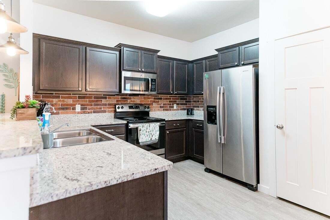 2118 9th Street Lubbock, TX 79401 - Photo 12 of 28 a kitchen with a refrigerator sink and microwave