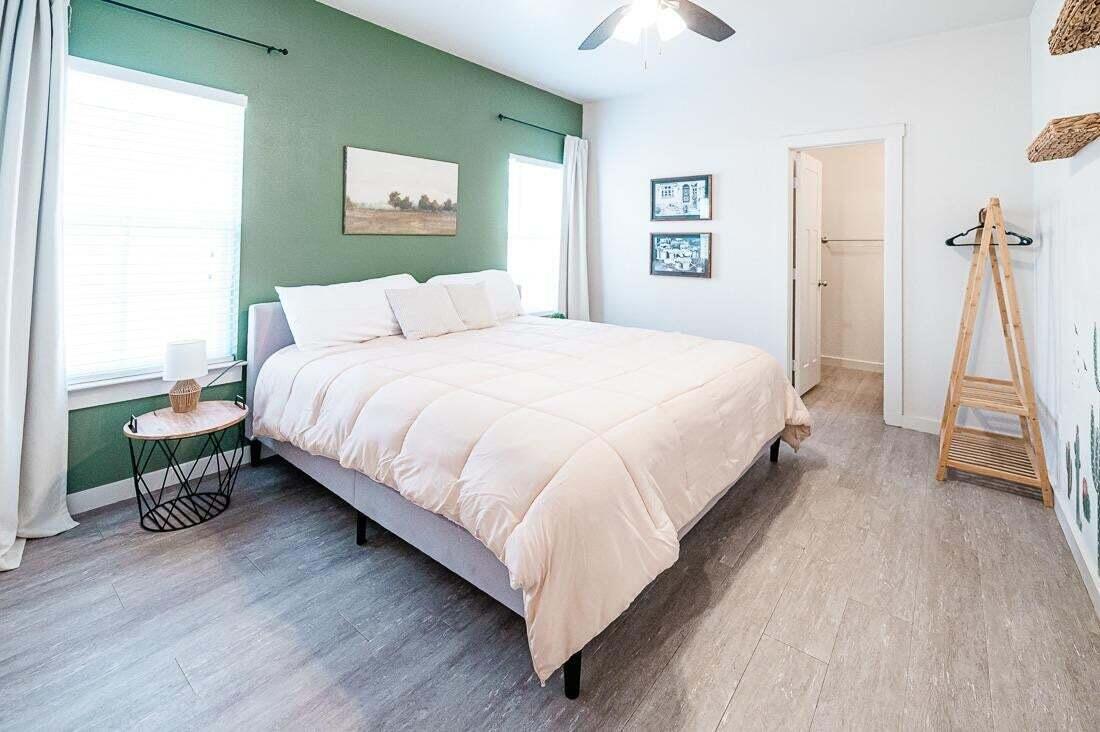 2118 9th Street Lubbock, TX 79401 - Photo 16 of 28 a large bed sitting in a bedroom and a table