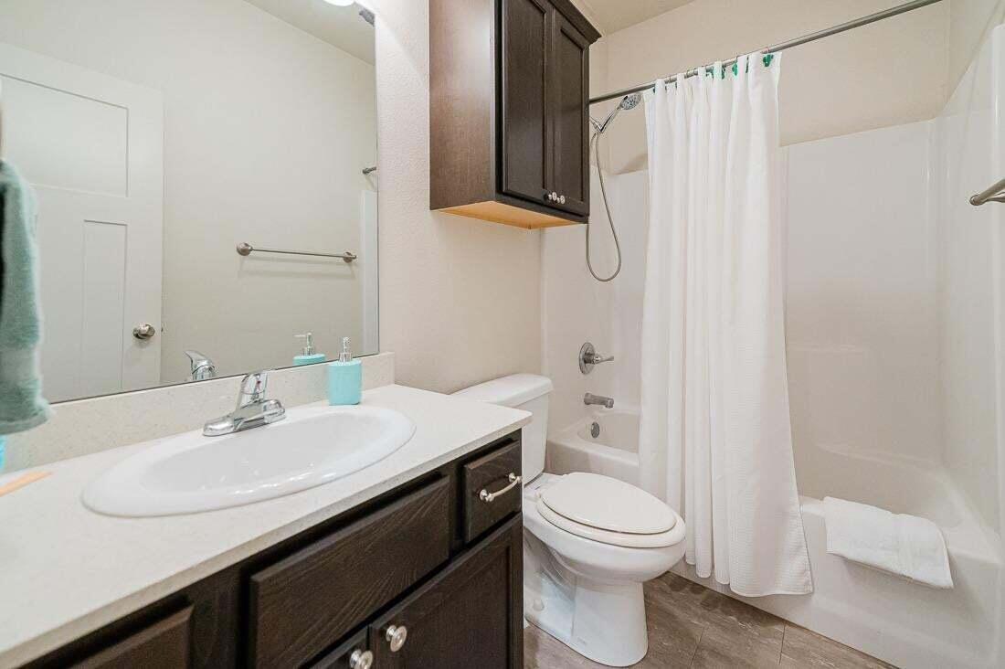 2118 9th Street Lubbock, TX 79401 - Photo 17 of 28 a bathroom with a sink toilet and shower