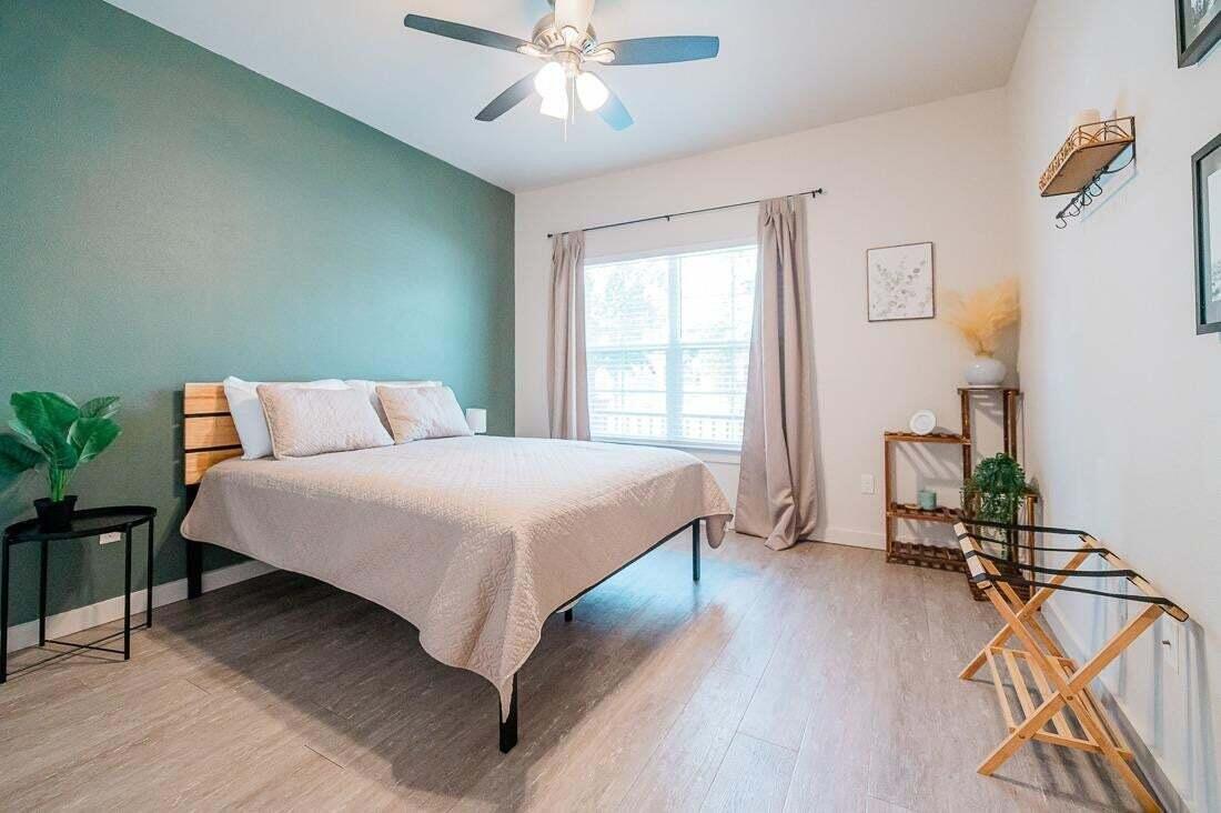 2118 9th Street Lubbock, TX 79401 - Photo 19 of 28 a bedroom with a bed and a chandelier