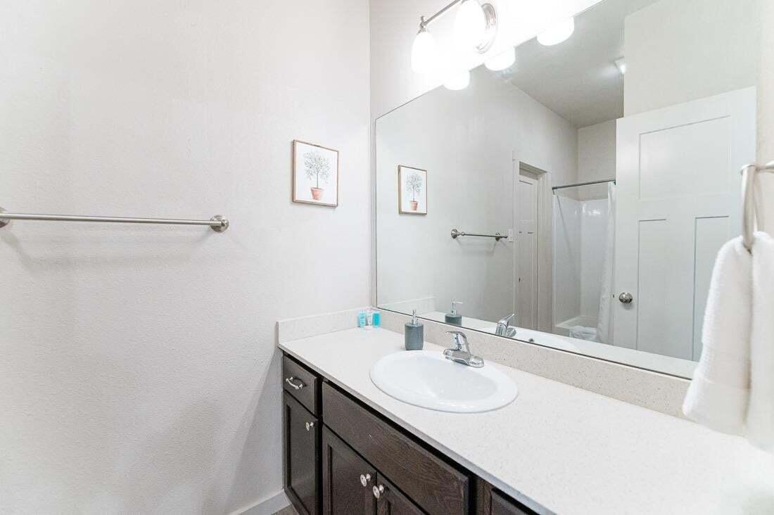 2118 9th Street Lubbock, TX 79401 - Photo 20 of 28 a bathroom with a sink and a mirror