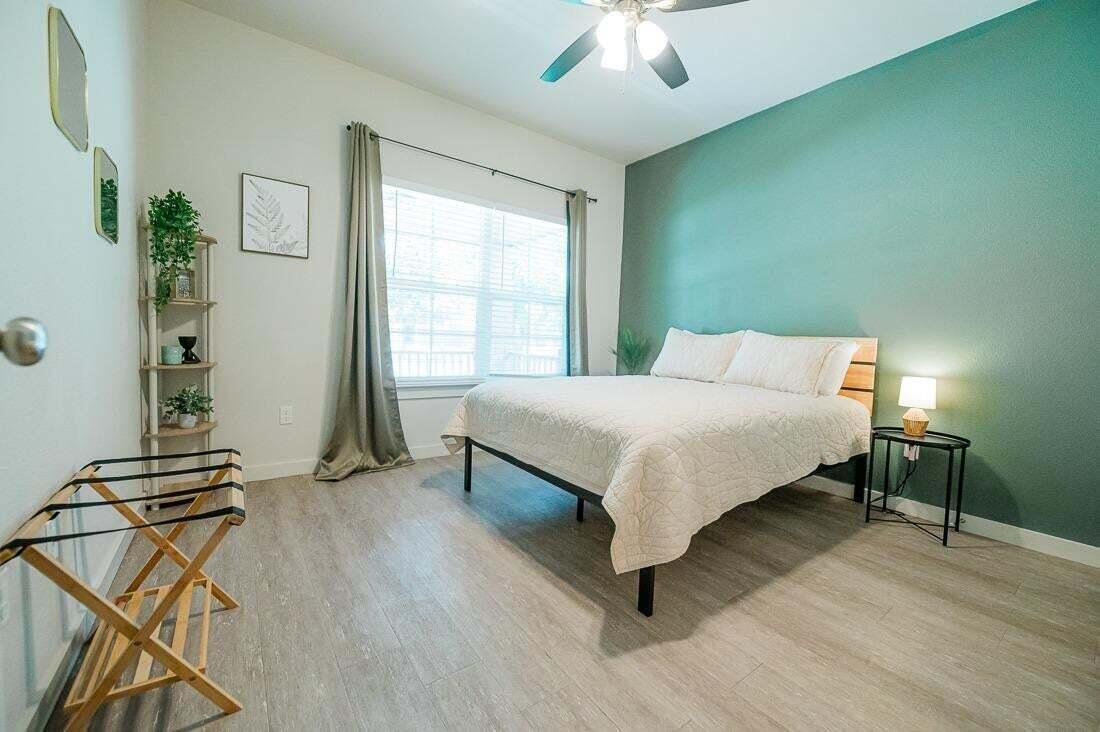 2118 9th Street Lubbock, TX 79401 - Photo 22 of 28 a bedroom with a bed and a chandelier