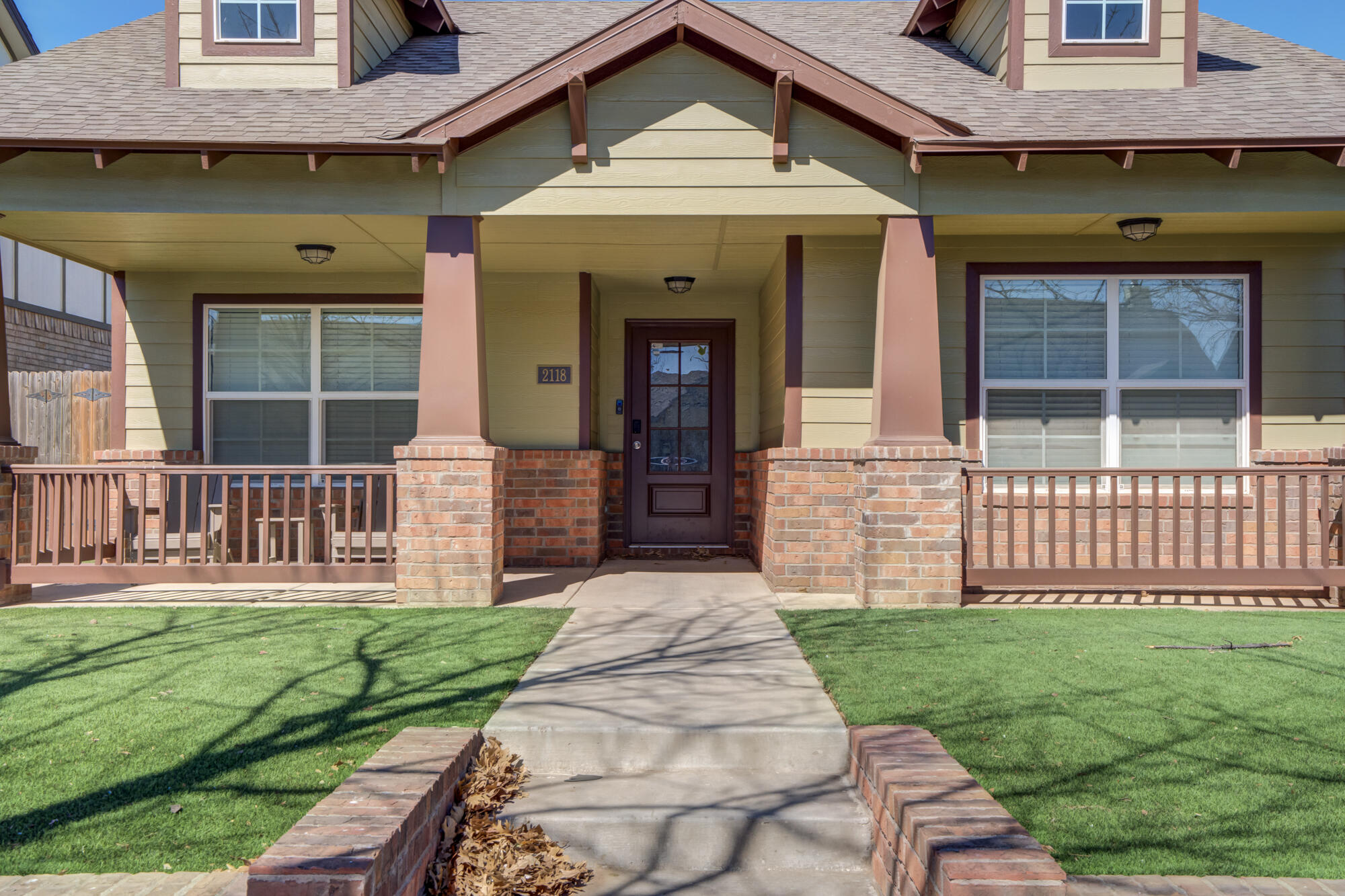 2118 9th Street Lubbock, TX 79401 - Photo 3 of 28 a front view of a house with a garden and porch