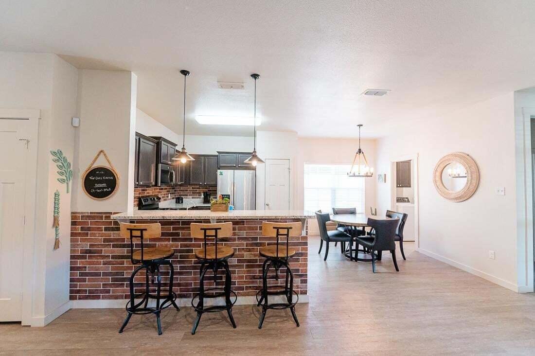 2118 9th Street Lubbock, TX 79401 - Photo 10 of 28 a large kitchen with a table and chairs