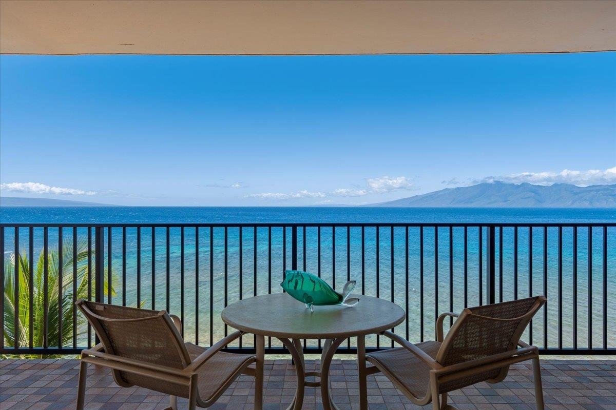 a balcony with a table and chairs