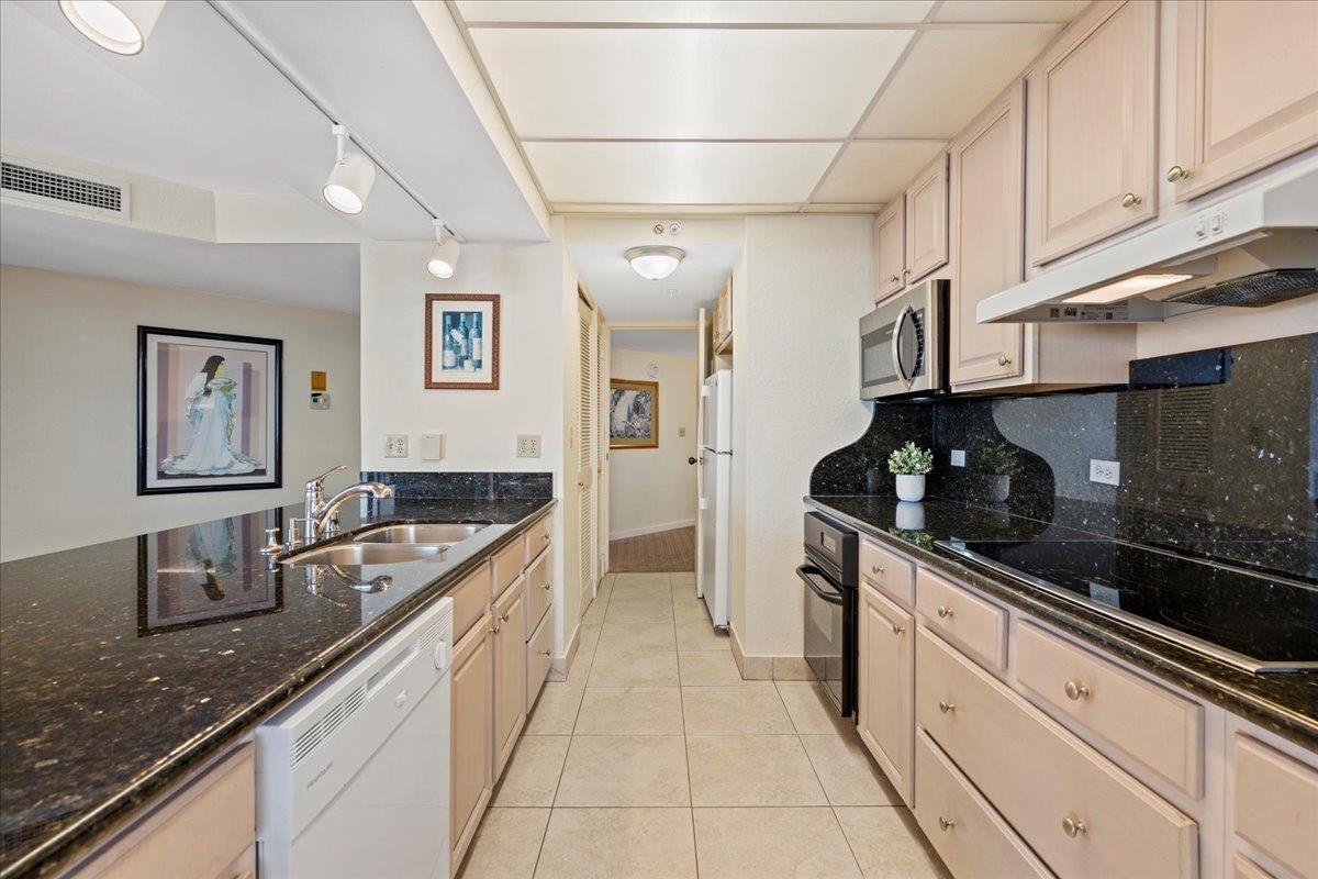 3445 Lower Honoapiilani Road, Unit 701 Lahaina, HI 96761 - Photo 11 of 40 a kitchen with stainless steel appliances granite countertop a sink and cabinets