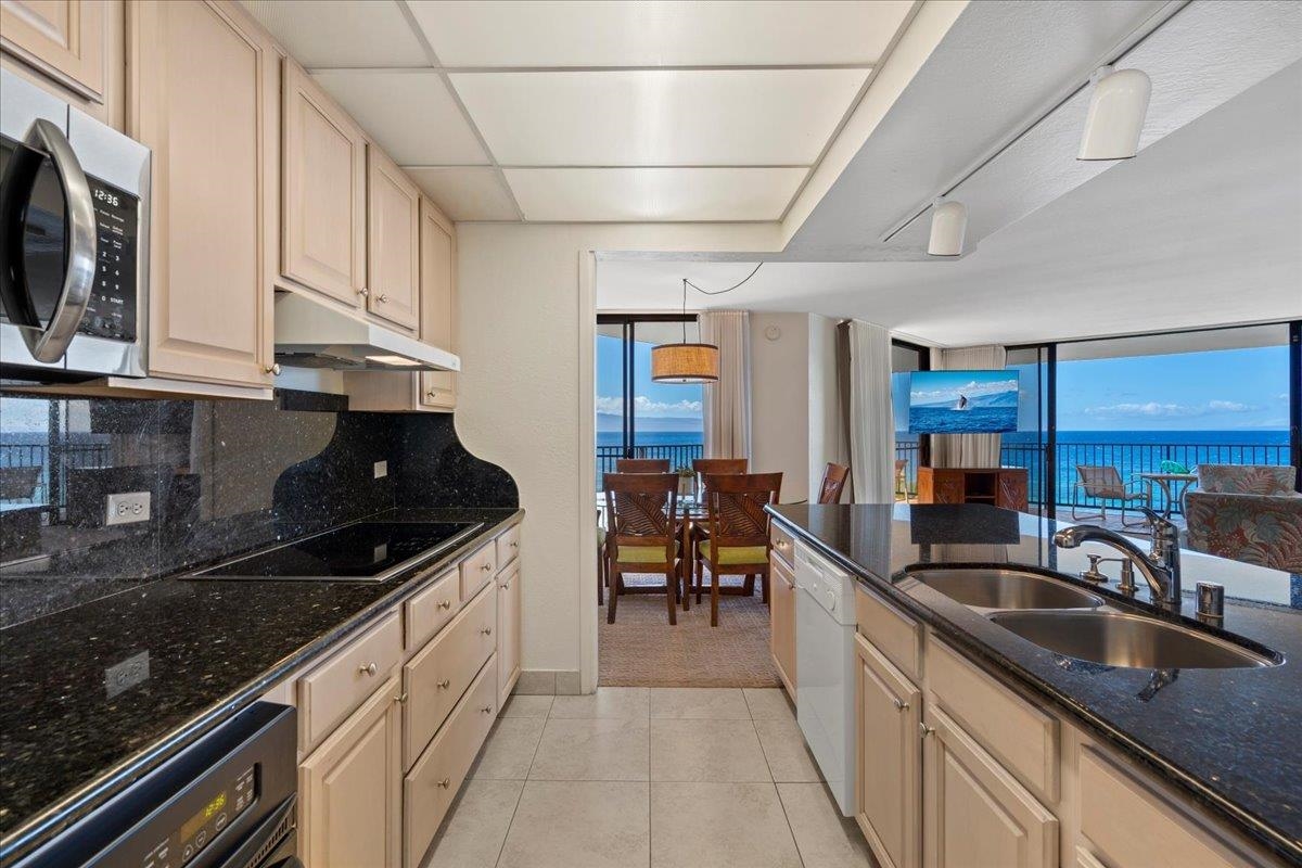 3445 Lower Honoapiilani Road, Unit 701 Lahaina, HI 96761 - Photo 12 of 40 a kitchen with granite countertop a sink a stove and cabinets