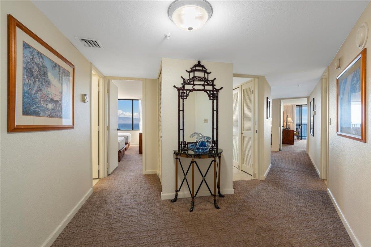 3445 Lower Honoapiilani Road, Unit 701 Lahaina, HI 96761 - Photo 2 of 40 a view of a hallway with a livingroom and a dinning area a chandelier