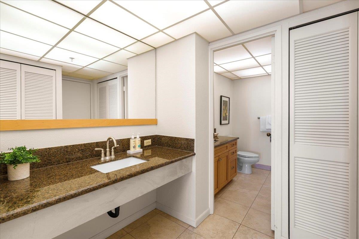 3445 Lower Honoapiilani Road, Unit 701 Lahaina, HI 96761 - Photo 28 of 40 a bathroom with a granite countertop sink a toilet and mirror