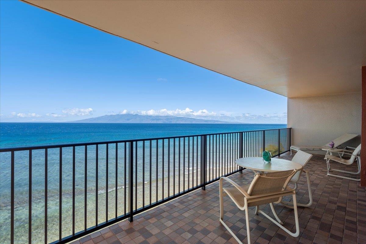 3445 Lower Honoapiilani Road, Unit 701 Lahaina, HI 96761 - Photo 6 of 40 a balcony with table and chairs