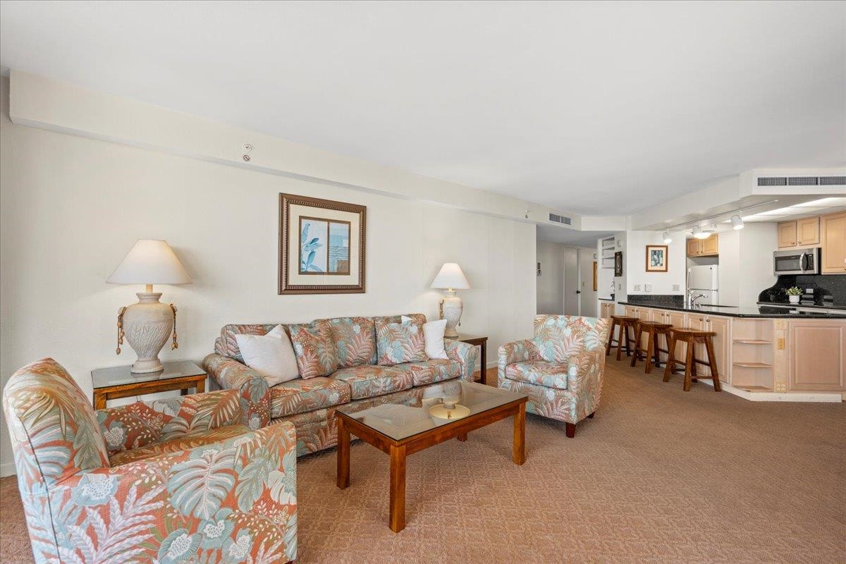 3445 Lower Honoapiilani Road, Unit 701 Lahaina, HI 96761 - Photo 9 of 40 a living room with furniture and a table