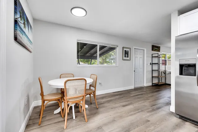 a view of a dining room with furniture and a floor to ceiling window