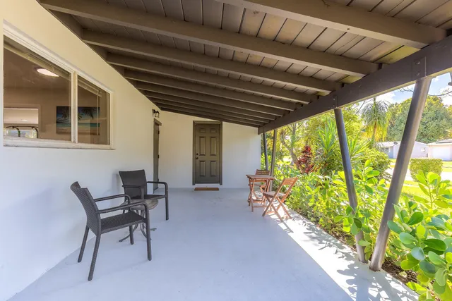 a dining room with furniture and a floor to ceiling window