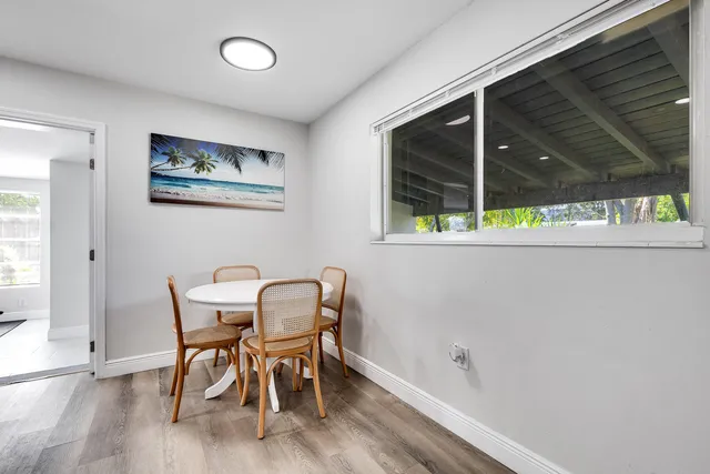 a view of a dining room that has a table and chairs in it