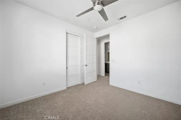 a view of a big room with a ceiling fan