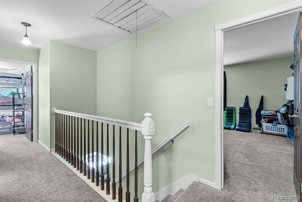 1476 County Farm Road Howell, MI 48843 - Photo 23 of 53 Corridor featuring carpet flooring, an upstairs landing, and attic access