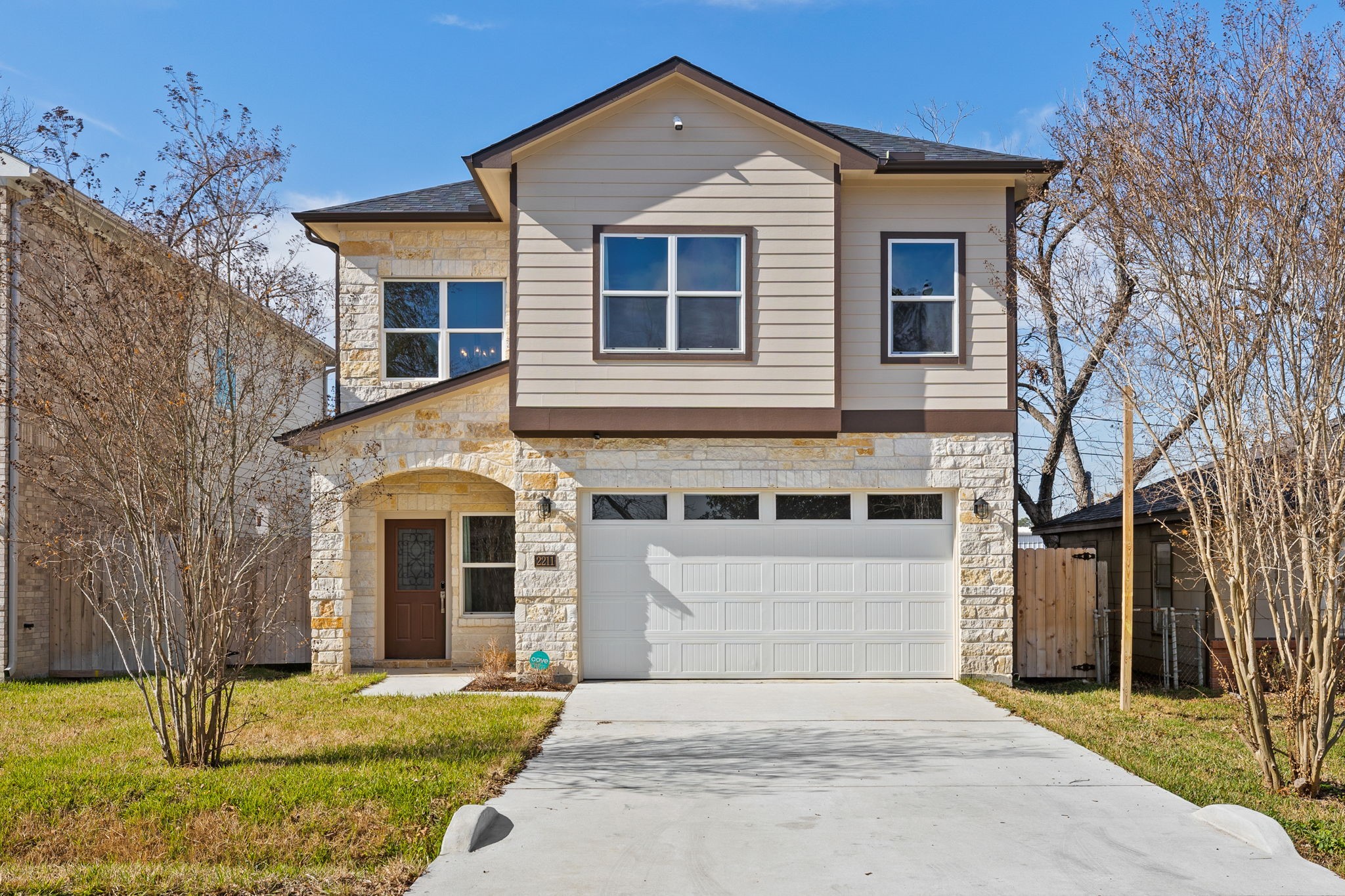 a front view of a house with a yard and garage