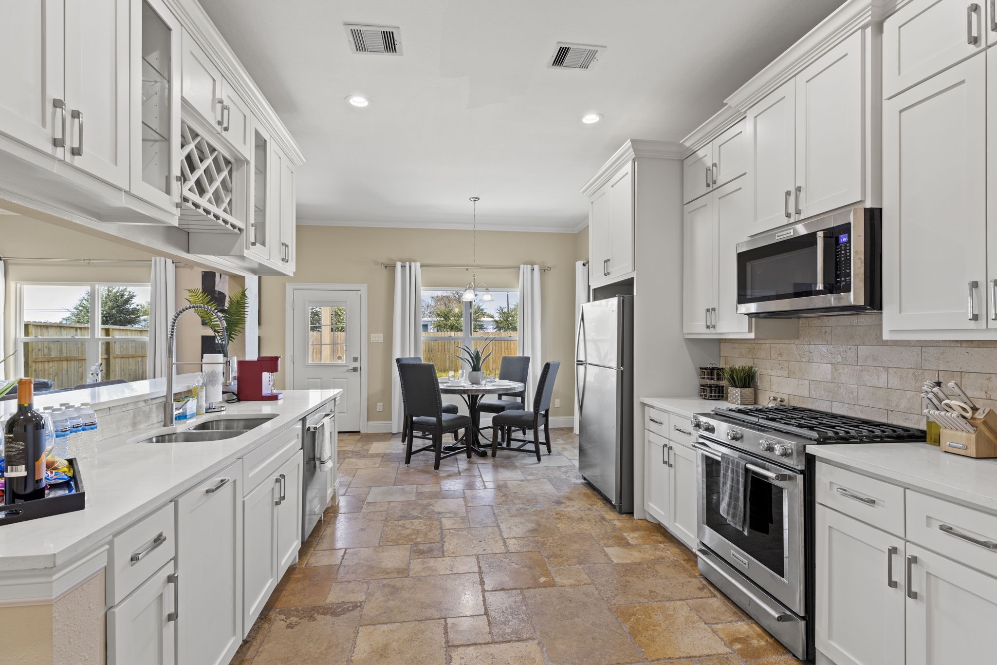 2211 Silverbonnet Street Houston, TX 77055 - Photo 12 of 39 a kitchen with stainless steel appliances kitchen island granite countertop a sink and cabinets