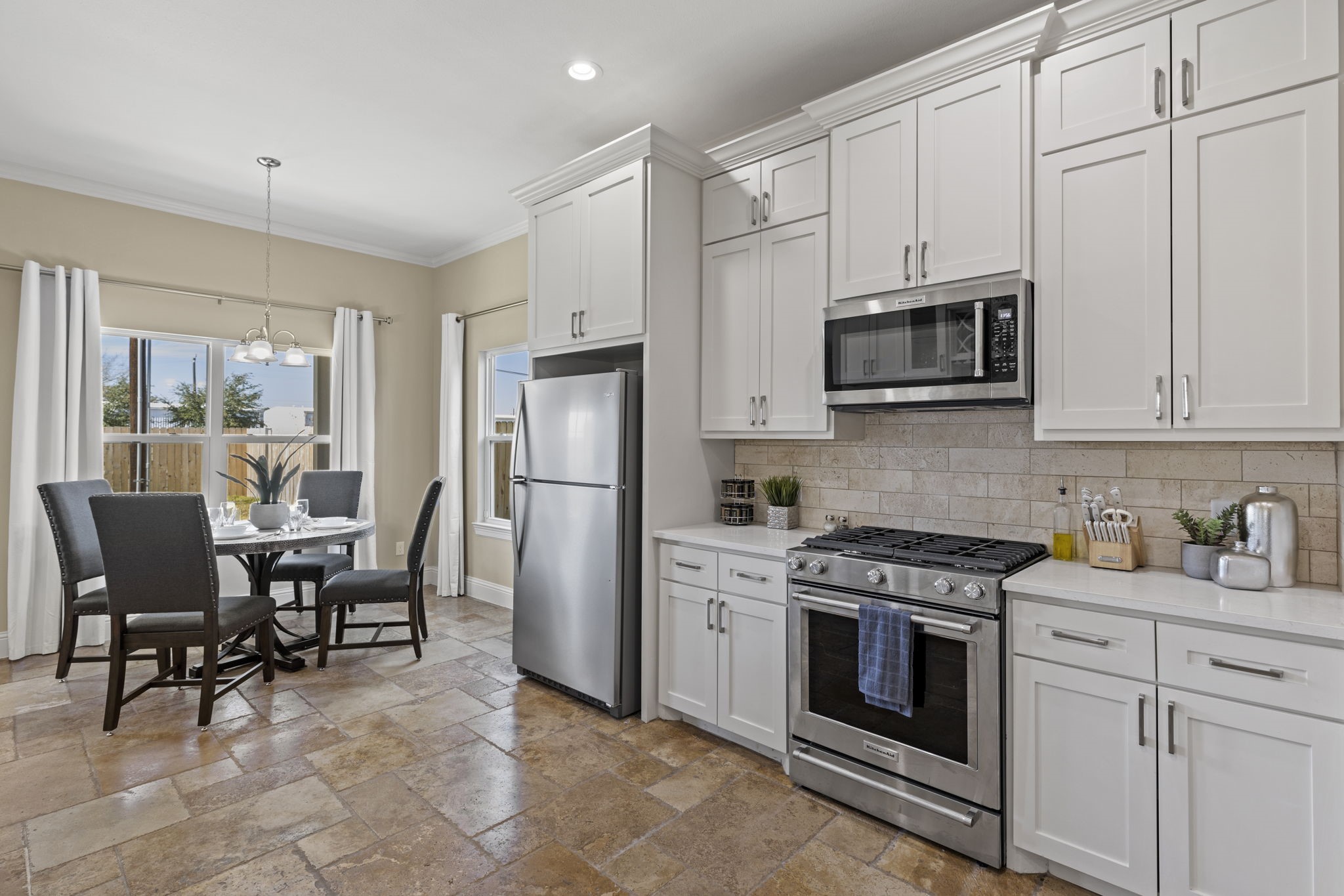 2211 Silverbonnet Street Houston, TX 77055 - Photo 13 of 39 a kitchen with stainless steel appliances a stove a sink cabinets and a refrigerator