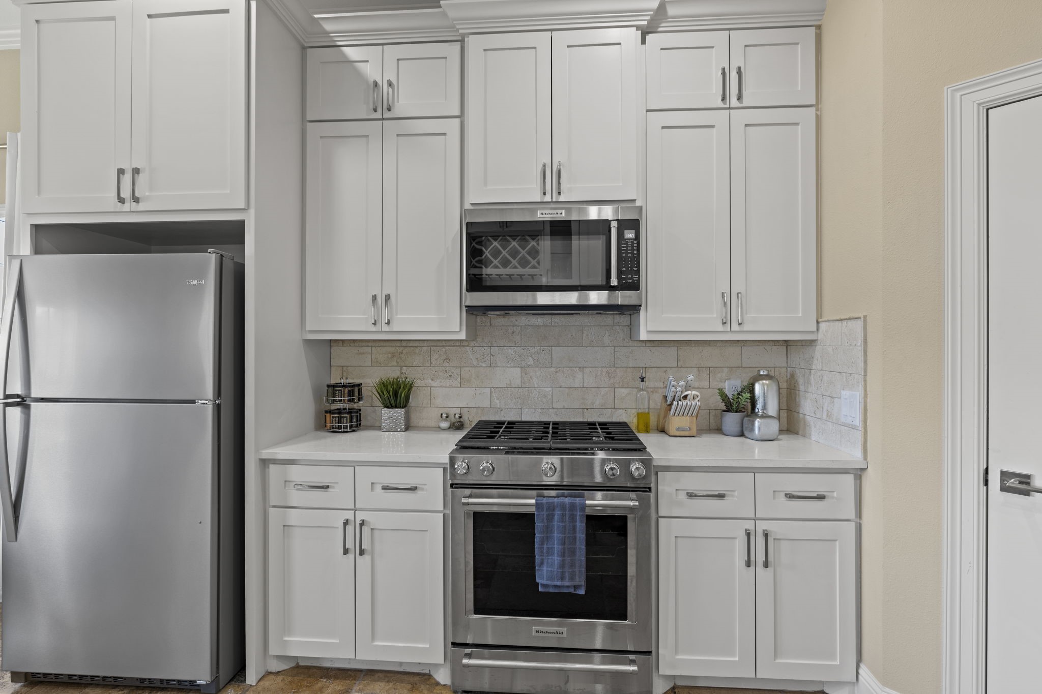 2211 Silverbonnet Street Houston, TX 77055 - Photo 14 of 39 a kitchen with stainless steel appliances white cabinets and a refrigerator