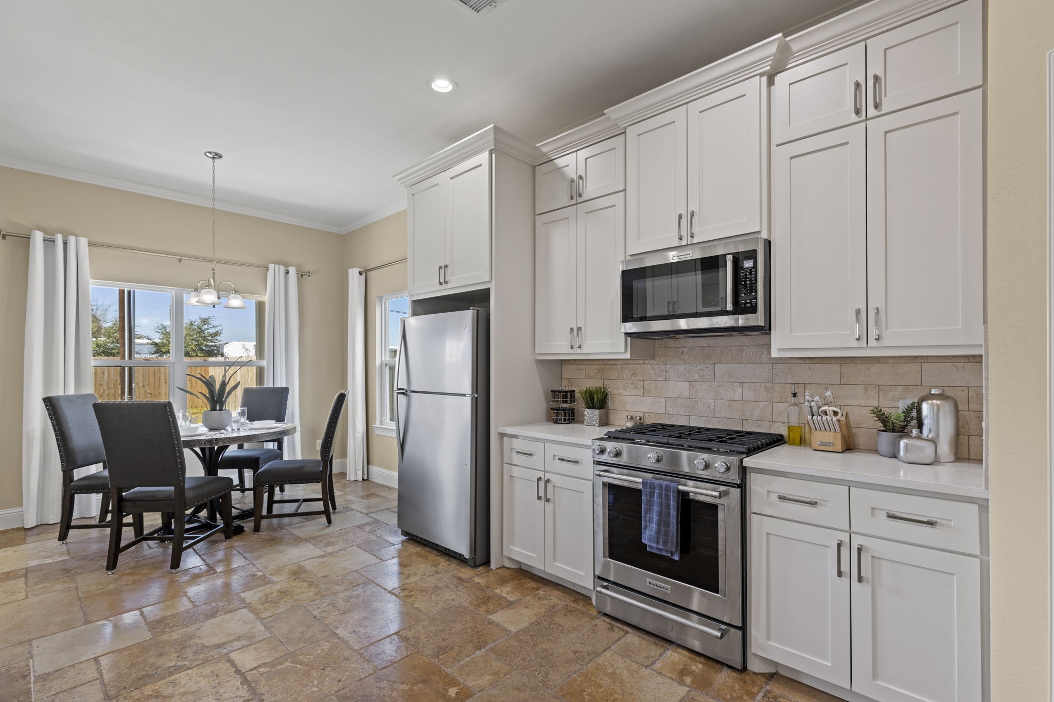 2211 Silverbonnet Street Houston, TX 77055 - Photo 17 of 39 a kitchen with stainless steel appliances a stove a sink refrigerator and white cabinets