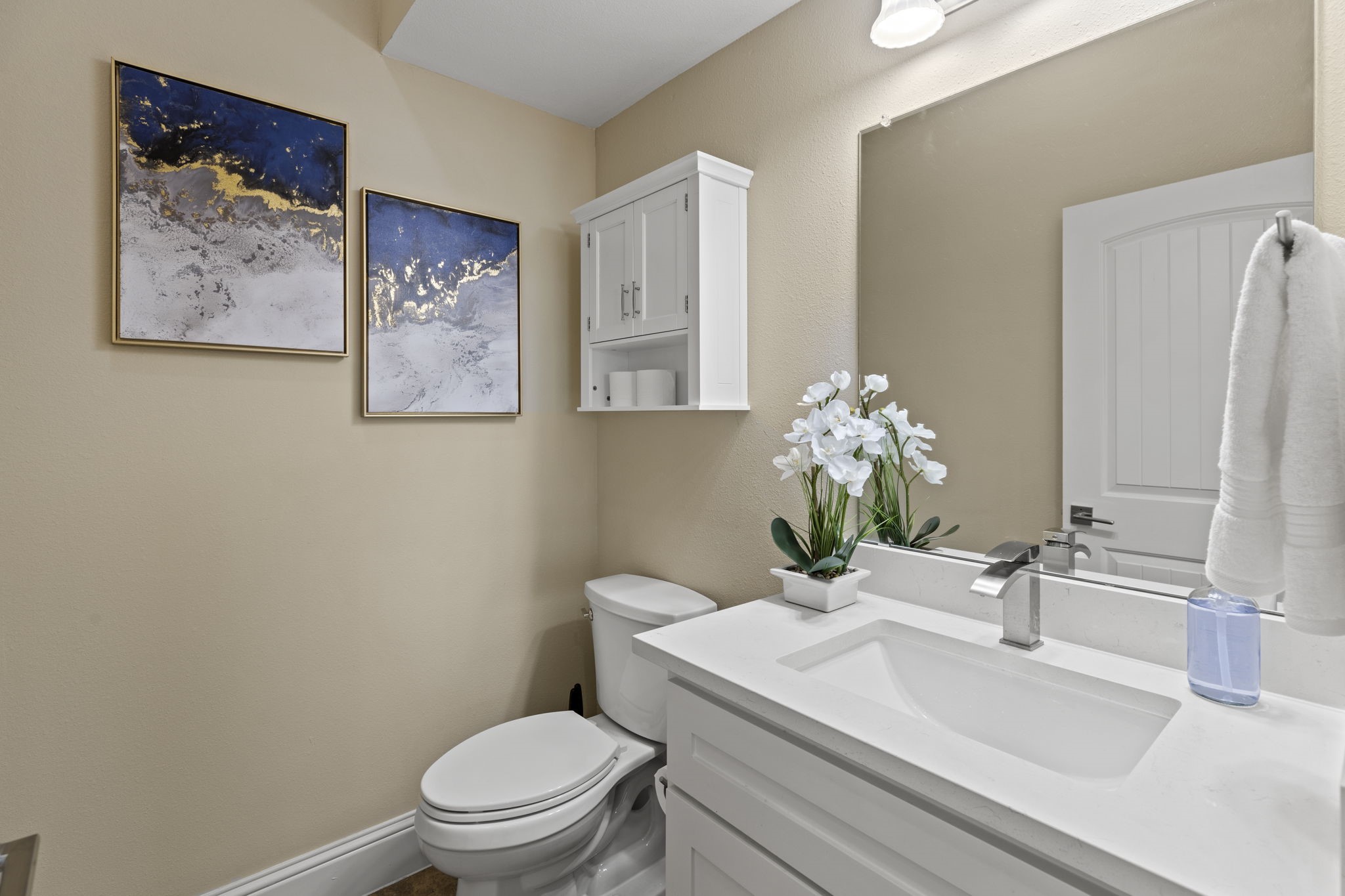 2211 Silverbonnet Street Houston, TX 77055 - Photo 21 of 39 a bathroom with a sink a toilet and a large mirror