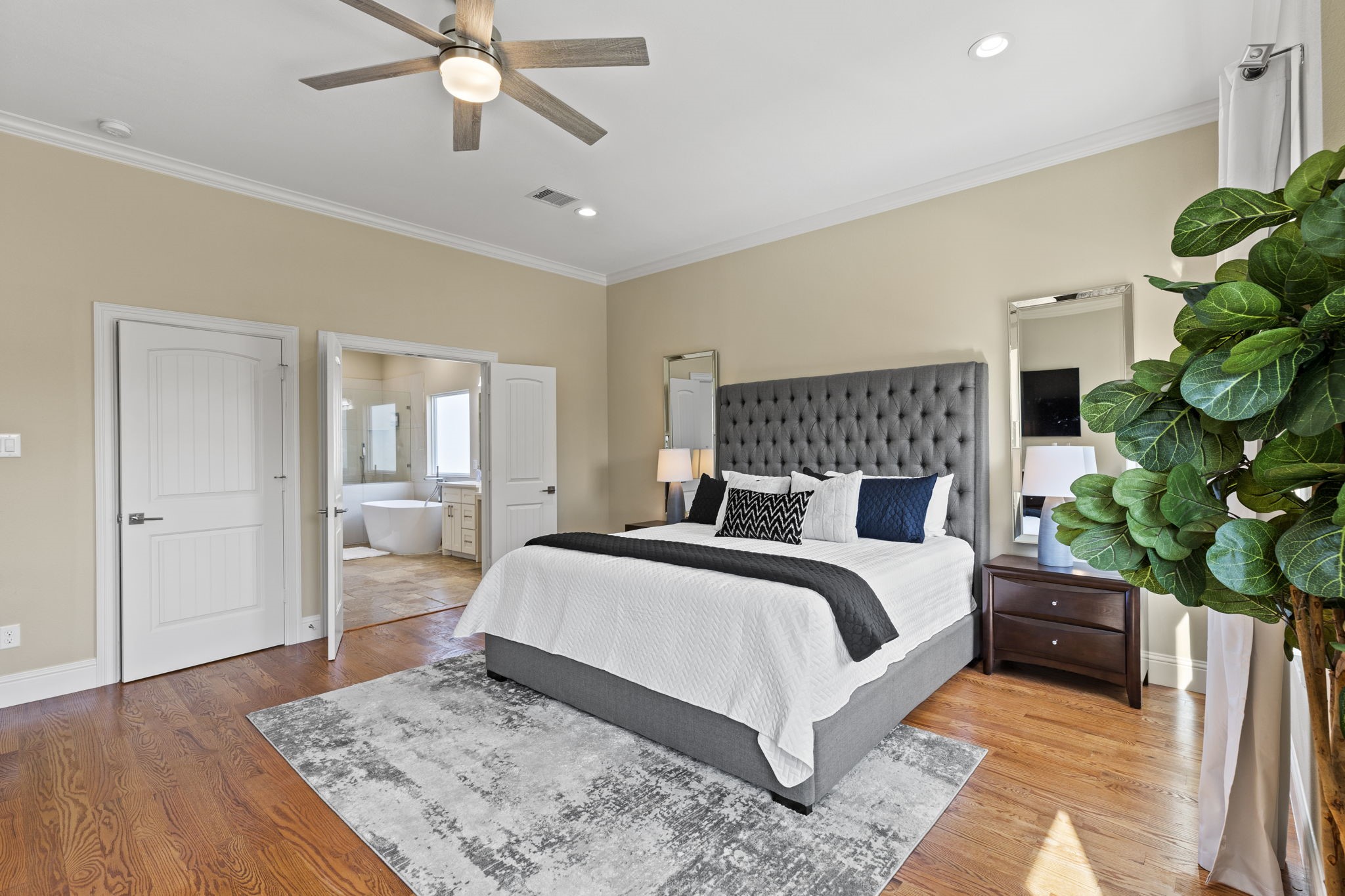 2211 Silverbonnet Street Houston, TX 77055 - Photo 25 of 39 a bedroom with a large bed and a potted plant