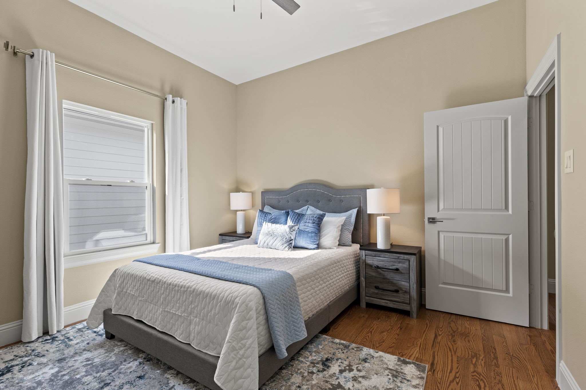 2211 Silverbonnet Street Houston, TX 77055 - Photo 33 of 39 a bedroom with a bed and wooden floor