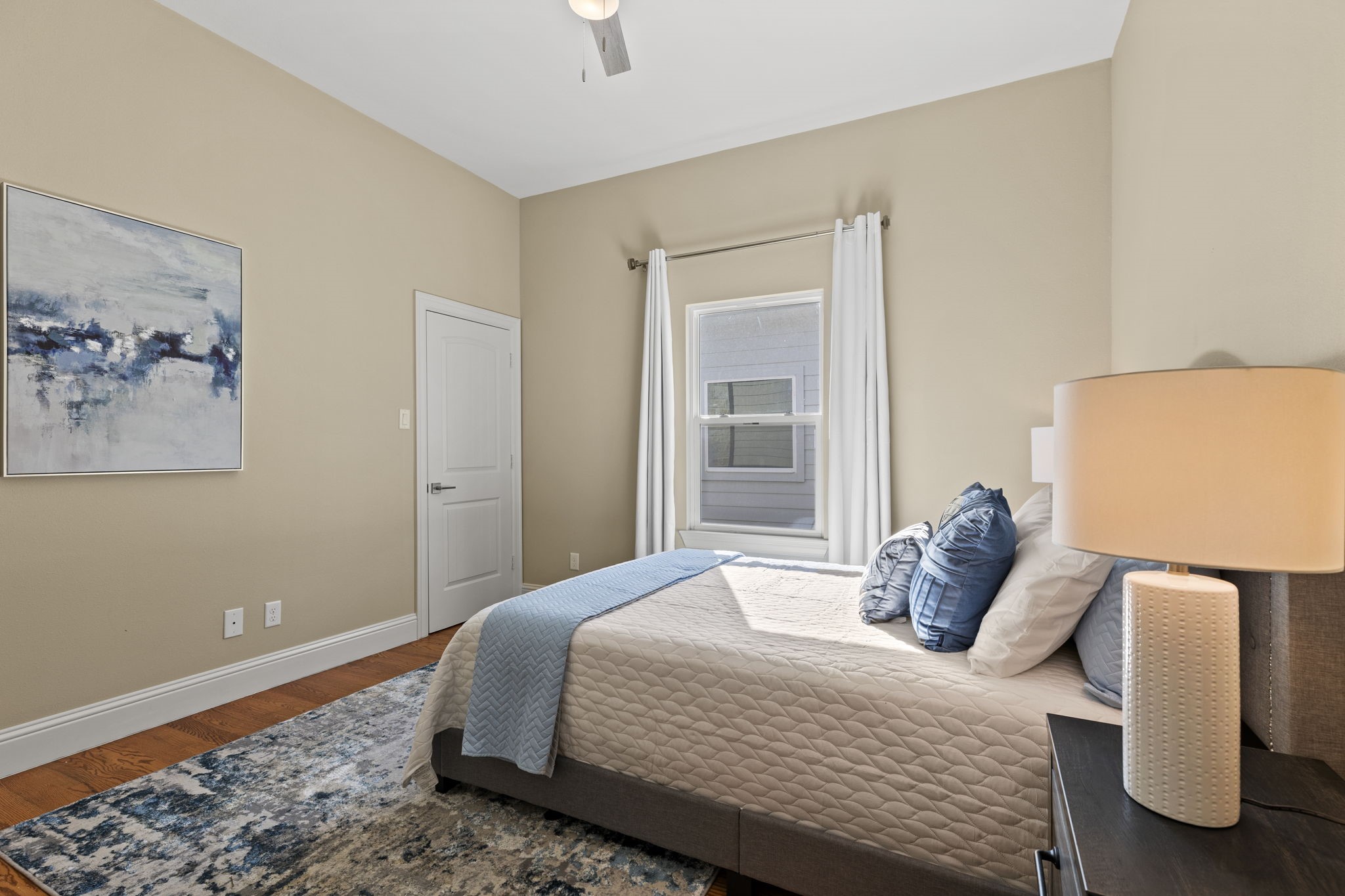 2211 Silverbonnet Street Houston, TX 77055 - Photo 34 of 39 a bedroom with a bed and wooden floor