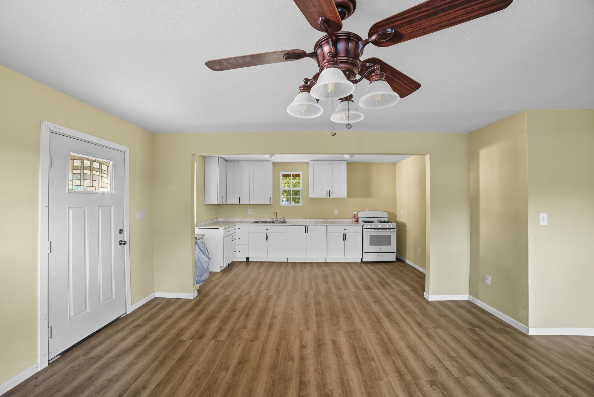 1413 South 2nd Street Temple, TX 76504 - Photo 12 of 24 a view of a kitchen with a refrigerator a ceiling fan and wooden floor