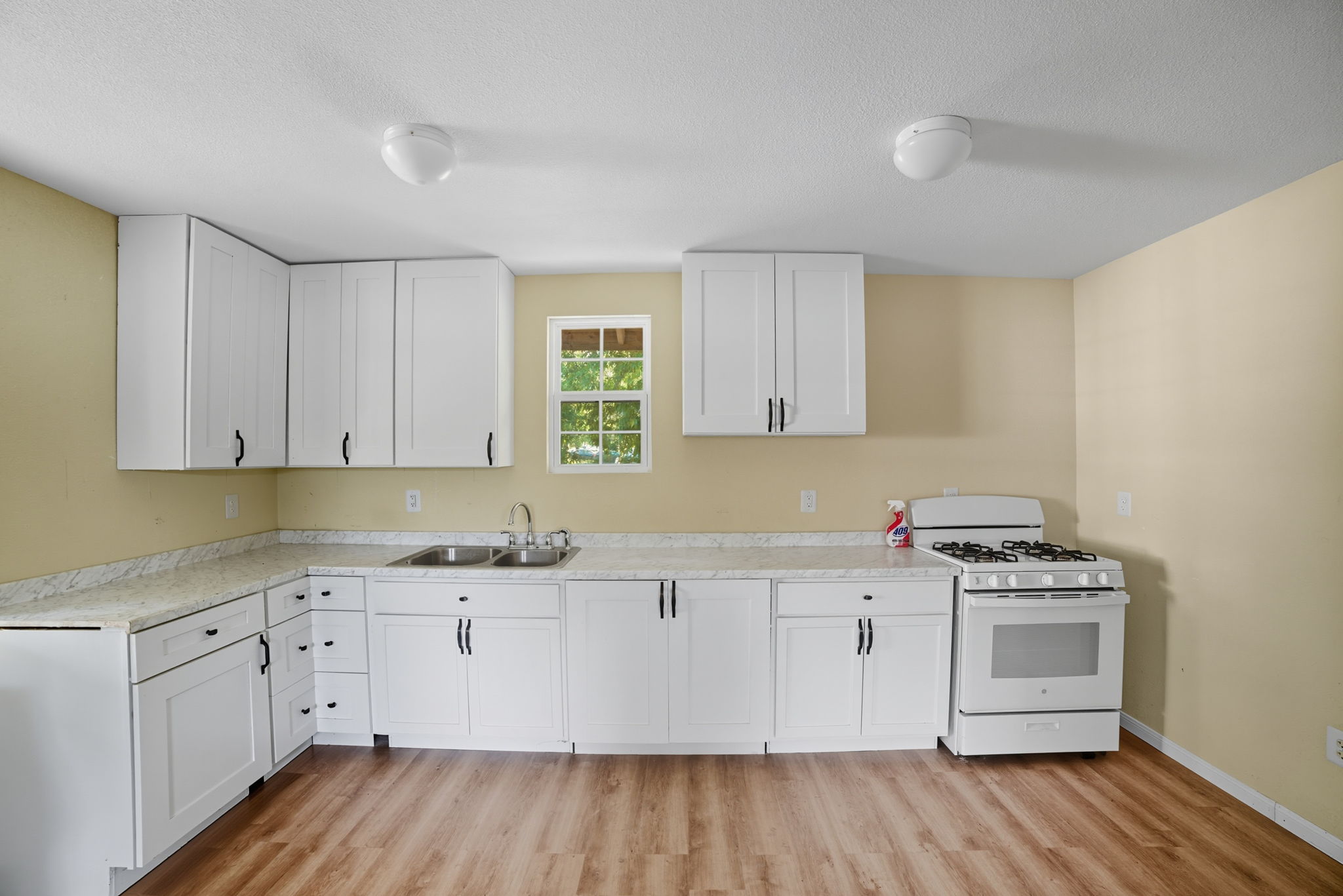 1413 South 2nd Street Temple, TX 76504 - Photo 14 of 24 a kitchen with a sink a stove and cabinets